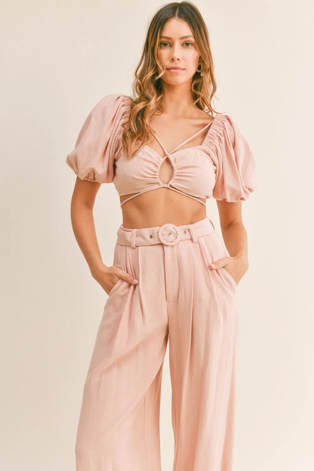 Close-up of the high-waist and self-belt detail on the wide-leg pants.