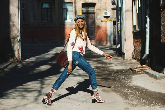 A confident woman smiling in a pair of high-waisted curvy jeans from Imperio by Johana, showcasing the perfect fit for an hourglass figure.