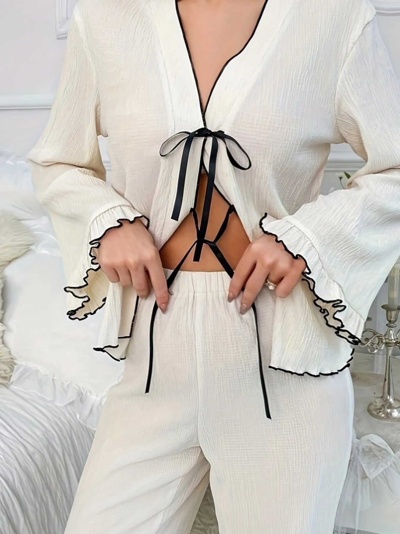 Close-up of the elegant self-tie bow detail on the lounge blouse.