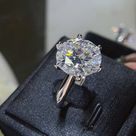 Moissanite ring with certificate of authenticity documentation.