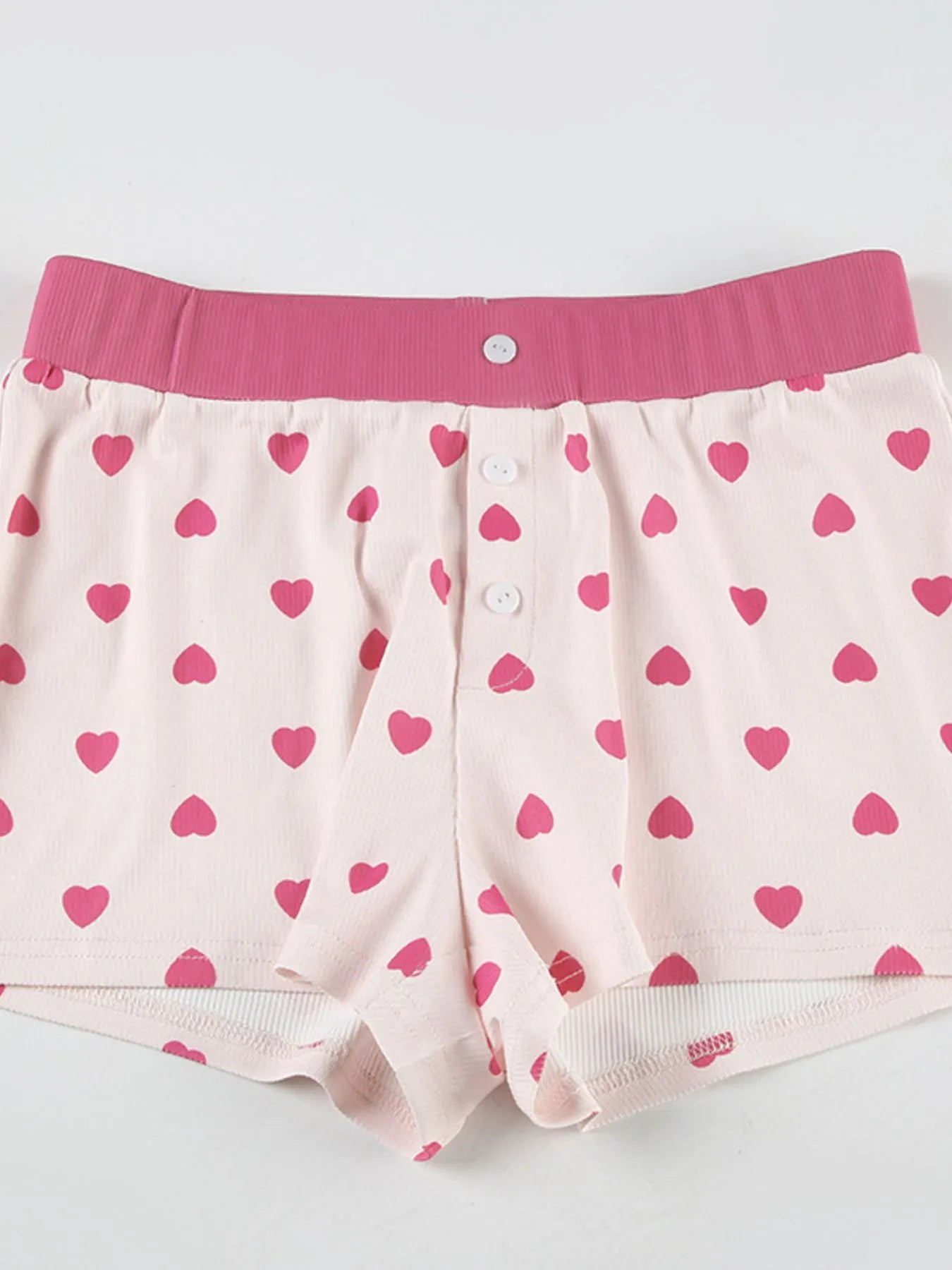 Pink heart-patterned boxer briefs with a pink waistband on a light gray background -  Impperio by Johana
