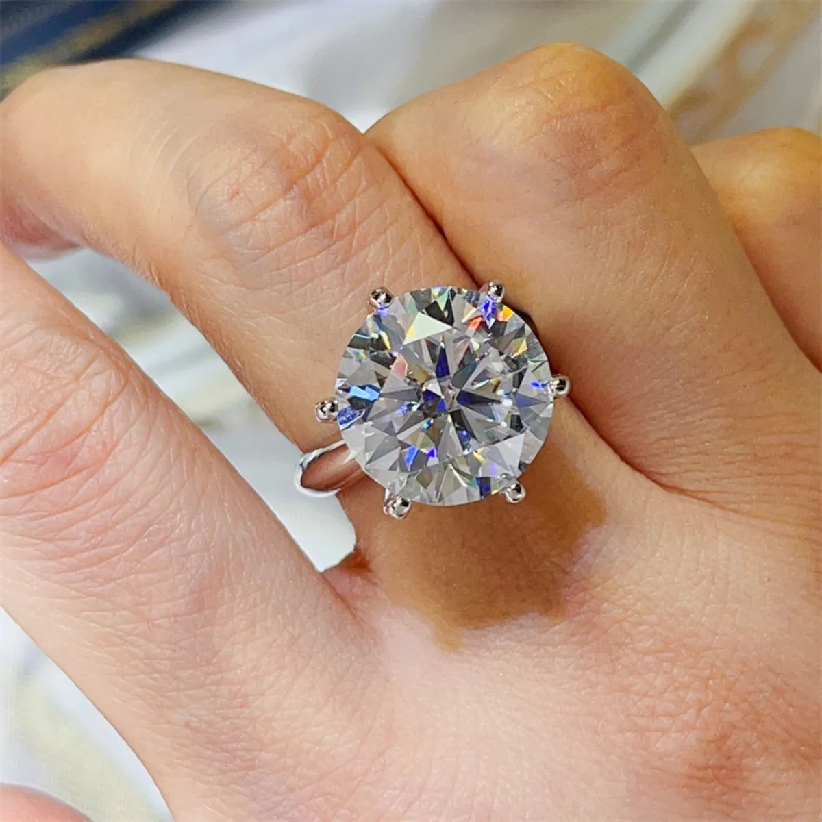 10 10-carat moissanite ring is being worn, showing scale and luxury appearance.