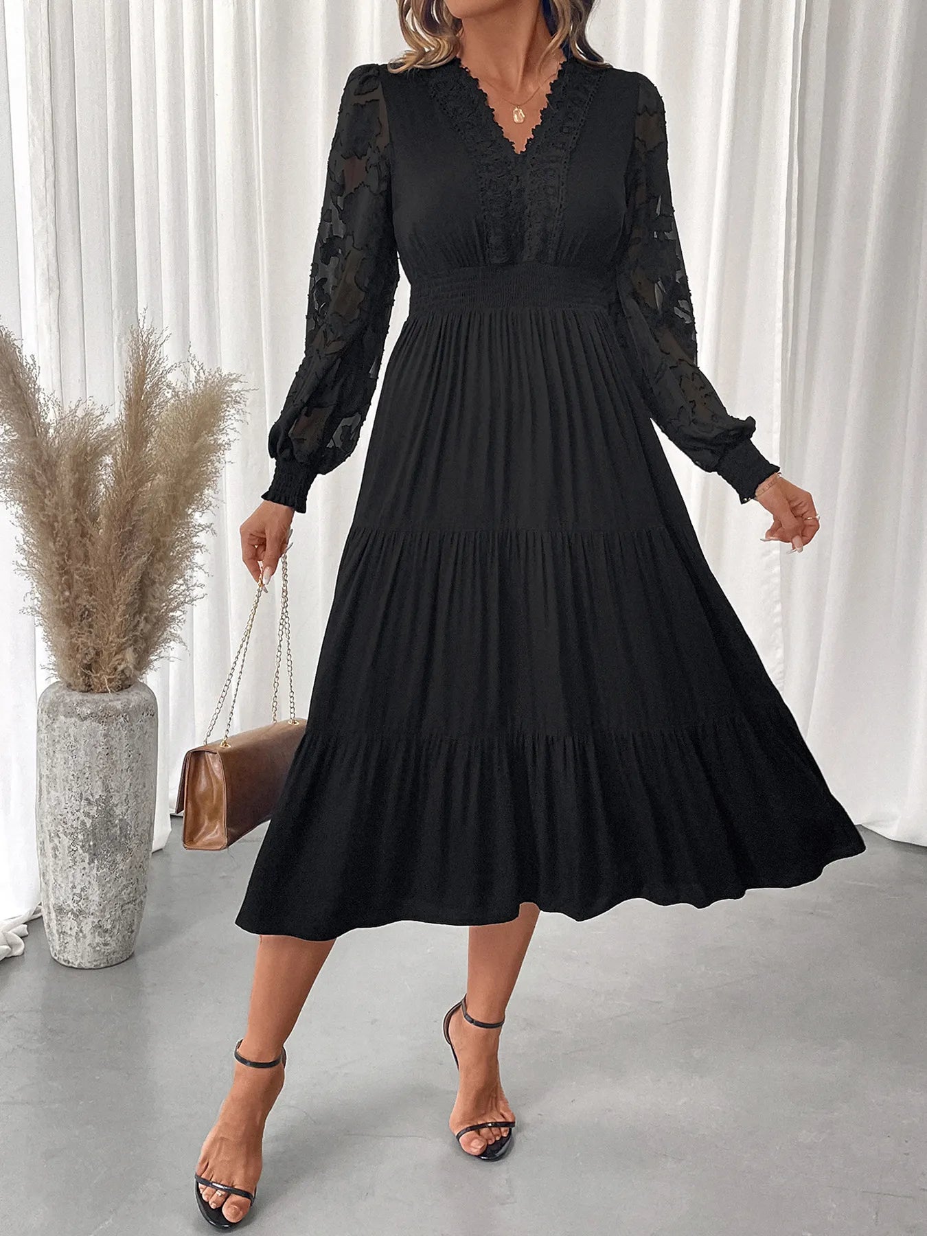 Close up of lace detailing on lantern sleeve tiered dress
